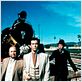 photo Buzz Kulik, Eric Idle, Pierce Brosnan